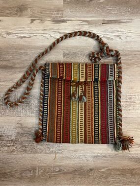 Boho woven ethnic blanket rug crossbody bag with braided strap and pompom detail